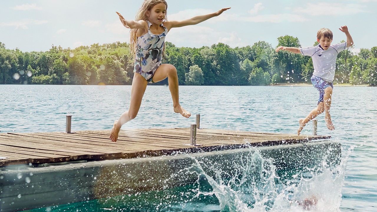 Kids jumping from pond in fresh water