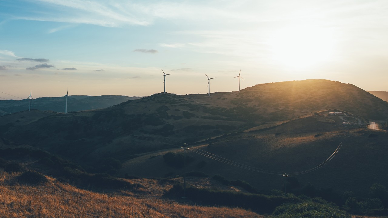 Sunset on beautiful landscape with windmills