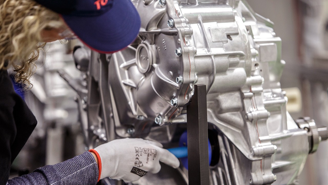 Toyota technician working on engine