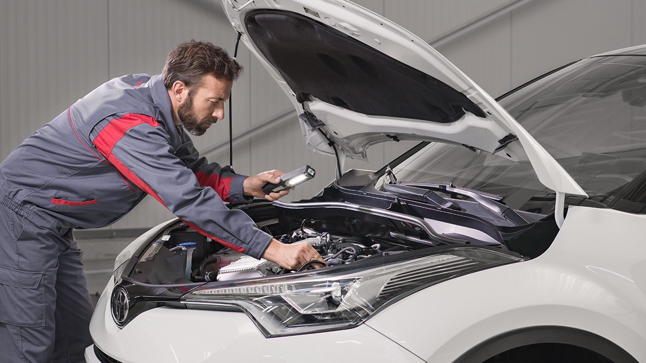 Toyota technician inspecting vehicle