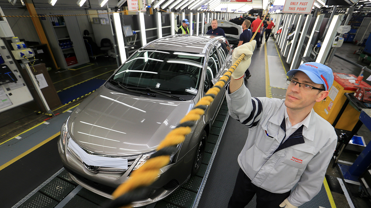 Toyota factory worker holding andon rope
