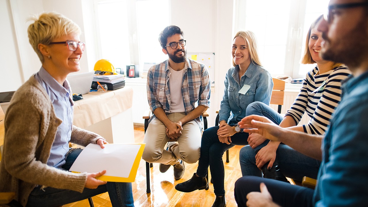 Group of people sitting in a circle, sharing knowledge