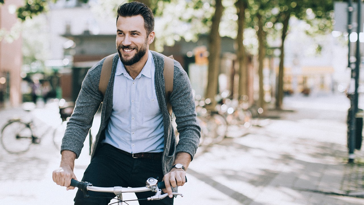 Businessman riding bicycle through the city