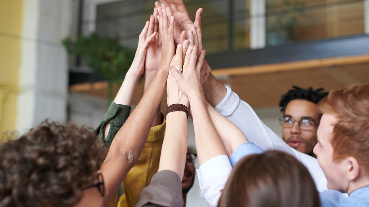 Business people with different nationalities joining their hands