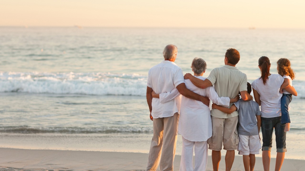 Happy family looking over the sea horizon