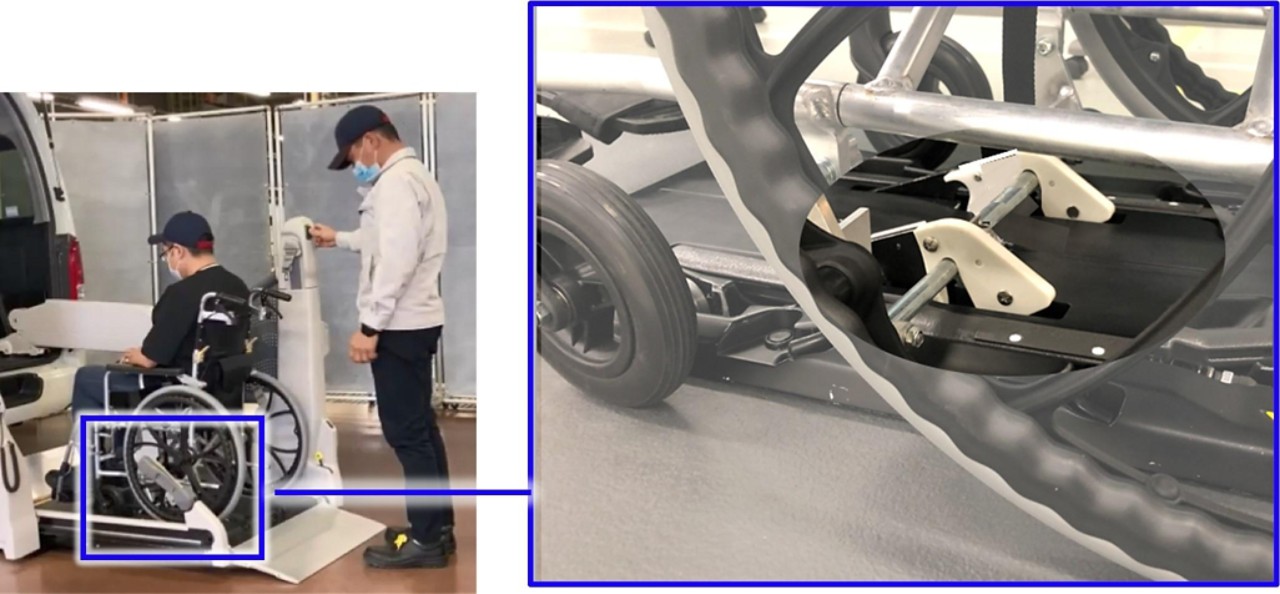 A person using our one-touch fastening device to secure their wheelchair in a vehicle